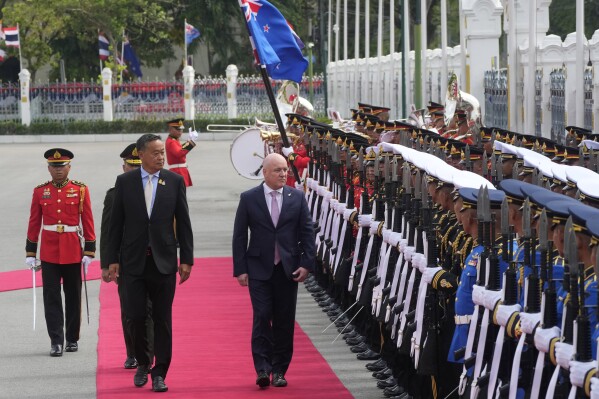 Thailand's Prime Minister Srettha Thavisin, front left, and New Zealand's Prime Minister Christopher Luxon, front right, review an honor guard during a welcome ceremony at the government house in Bangkok, Thailand, Wednesday, April 17, 2024. (AP Photo/Sakchai Lalit)