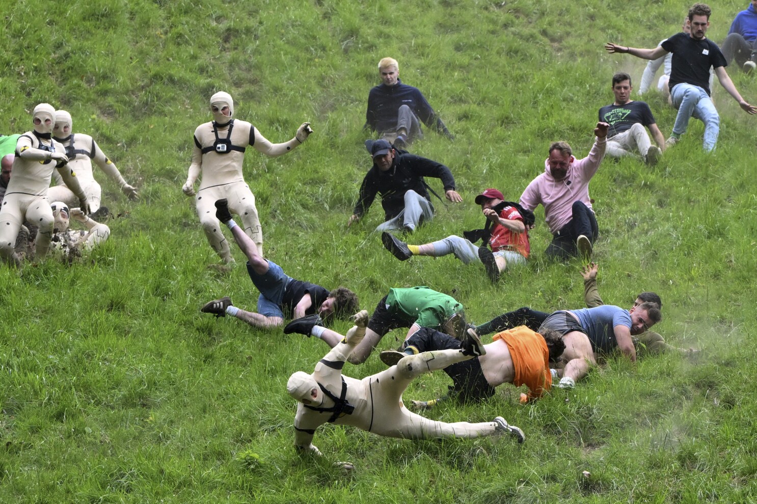 Runners trip, stumble and roll their way to victory in annual downhill cheese chase