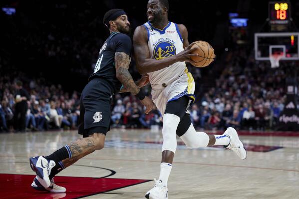 Golden State Warriors forward Draymond Green drives to the basket past Portland Trail Blazers guard Gary Payton II during the first half of an NBA basketball game in Portland, Ore., Wednesday, Feb. 8, 2023. (AP Photo/Craig Mitchelldyer)