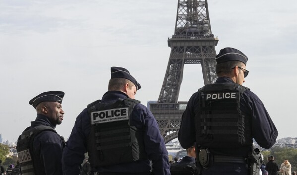 FILE - Police officers patrol the Trocadero plaza near the Eiffel Tower in Paris, Tuesday, Oct. 17, 2023. France says it has asked 46 countries if they can supply more than 2,000 police officers to help secure the Paris Olympics. Organizers are finalizing security planning for the July 26-Aug. 11 Games, the French capital’s first in a century. (AP Photo/Michel Euler, File)