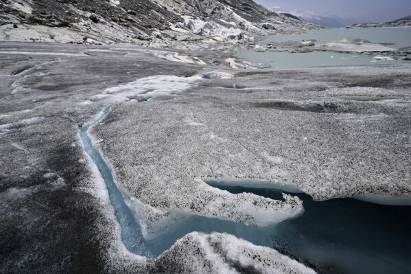 Water flows from the melting Rhone Glacier near Goms, Switzerland, June 10, 2025. (AP Photo/Matthias Schrader)
