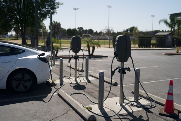 Electric vehicle chargers are seen in the parking lot of South El Monte High School in South El Monte, Calif., Aug. 26, 2022. (AP Photo/Jae C. Hong, File)