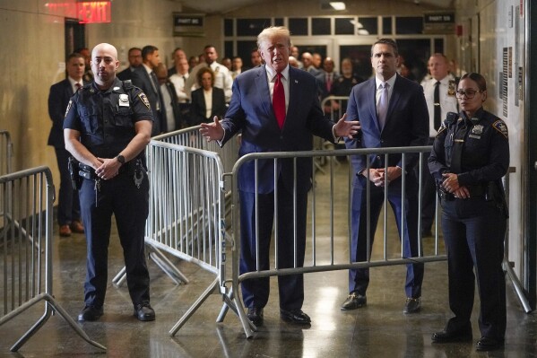 Former President Donald Trump speaks before entering the courtroom at Manhattan criminal court, Thursday, Feb. 15, 2024, in New York. A New York judge says former President Donald Trump's hush-money trial will go ahead as scheduled with jury selection starting on March 25. (AP Photo/Mary Altaffer)