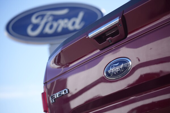 FILE - A 2021 F-150 pickup truck at a Ford dealer in southeast Denver, Oct. 24, 2021. Ford is recalling more than 870,000 newer F-150 pickup trucks in the U.S. because the electric parking brakes can turn on unexpectedly. The recall covers certain pickups from the 2021 through 2023 model years with single exhaust systems. Ford's F-Series pickups are the top-selling vehicles in the U.S. (AP Photo/David Zalubowski, File)