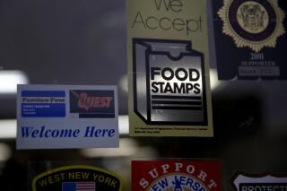 FILE - In this Jan. 12, 2015 file photo, a supermarket displays stickers indicating they accept food stamps in West New York, N.J. The Biden administration has approved a significant and permanent increase in the levels of food stamp assistance available to needy families—the largest single increase in the program’s history. Starting in October 2021, average benefits for food stamps (officially known as the SNAP program) will rise more than 25 percent above pre-pandemic levels. (AP Photo/Seth Wenig, File)