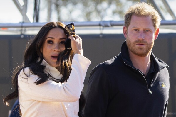 FILE - Prince Harry and Meghan Markle, Duke and Duchess of Sussex visit the track and field event at the Invictus Games in The Hague, Netherlands, Sunday, April 17, 2022. The production company founded by Prince Harry and his wife, Meghan, are splitting ways with Spotify, Friday, June 16, 2023, less than a year after the debut of their podcast “Archetypes."(AP Photo/Peter Dejong, File)