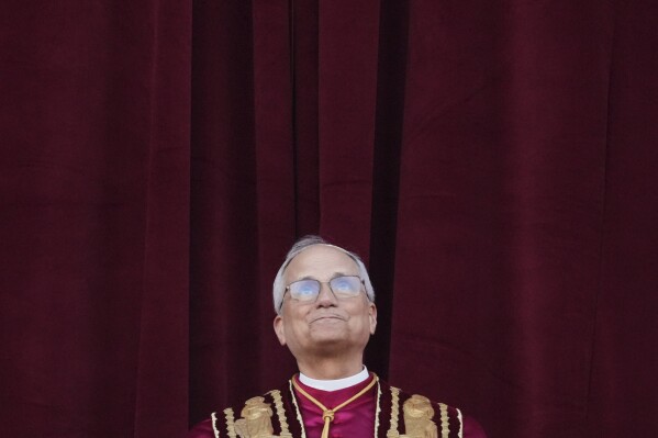 Newly elected Pope Leo XIV appears at the balcony of St. Peter's Basilica at the Vatican, Thursday, May 8, 2025. (AP Photo/Alessandra Tarantino)