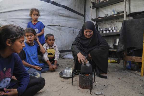 Ghalia Abu Moteir, whose family fled what is now Israel during the 1948 war that surrounded its creation, shelters from the current war in a tent in Khan Younis, Gaza Strip, after being displaced from her home in Rafah, Wednesday, May 14, 2025. (AP Photo/Abdel Kareem Hana)