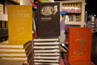 FILE - Books by Roald Dahl are displayed at the Barney's store on East 60th Street in New York on Monday, Nov. 21, 2011. Critics are accusing the publisher of Roald Dahl’s classic children’s books of censorship after it removed colorful language from stories such as “Charlie and the Chocolate Factory” and “Matilda” to make them more acceptable to modern readers. (AP Photo/Andrew Burton, File)