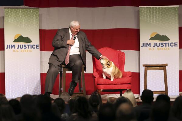 West Virginia Gov. Jim Justice pets his dog Babydog during an announcement for his U.S. Senate campaign, Thursday, April 27, 2023, at The Greenbrier Resort in White Sulphur Springs, W.Va. (AP Photo/Chris Jackson)