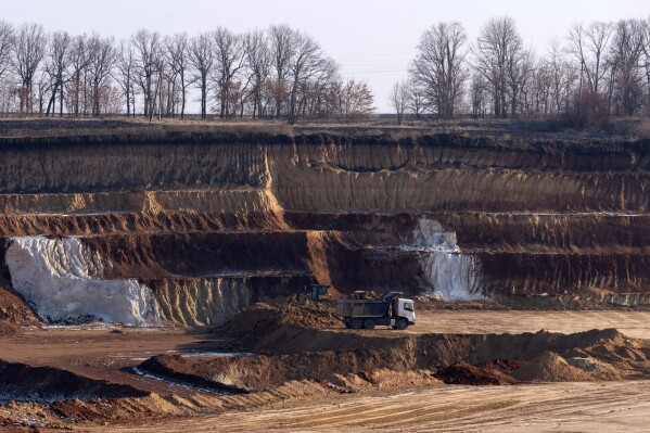 A mining haul truck transports a load at an ilmenite open pit mine in a canyon in the central region of Kirovohrad, Ukraine, Wednesday, Feb. 12, 2025. (AP Photo/Efrem Lukatsky)
