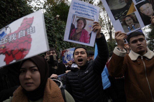 FILE - Protesters chant slogans as they hold posters and pictures of victims during a protest against China's brutal crackdown on ethnic group Uyghurs, in front of the Chinese consulate in Istanbul, Turkey, Wednesday, Nov. 30, 2022. Turkey's foreign minister has urged Chinese authorities to protect the cultural rights of minority Muslim Uyghurs in China's western Xinjiang province and allow them to "live their values," a Turkish official said Wednesday, June 5, 2024. (AP Photo/Khalil Hamra, File)