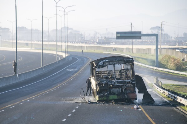 A burnt out bus stands on a freeway on the outskirts of Cape Town, South Africa, Tuesday, Aug. 7, 2023. Two people were fatally shot on a fifth day of violent protests in sparked by a dispute last week between minibus taxi drivers and authorities. The unrest on the outskirts of South Africa’s second-largest city follows an announcement last Thursday of a weeklong strike by minubus taxi drivers angered at what they call heavy-handed tactics by police and city authorities. (AP Photo)