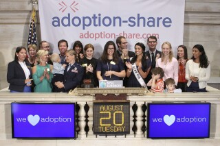 In this photo provided by the New York Stock Exchange, Adoption-Share founder and CEO Thea Ramirez, center, Miss Utah USA 2013 Marissa Powell, center right, and fellow adoption supporters ring the opening bell at the New York Stock Exchange in New York on Aug. 20, 2013. An Associated Press investigation found that Adoption-Share’s tool known as Family-Match – among the few adoption algorithms on the market in 2023 – has produced limited results in the states where it has been used, according to the organization’s self-reported data that AP obtained through public records requests from state and local agencies. (NYSE via AP)
