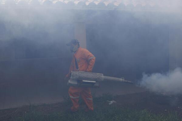 FILE - A city worker fumigates for Aedes aegypti mosquitoes inside a school in Santa Cruz, Bolivia, Thursday, Feb. 4, 2016. On Feb. 15, 2023, hospitals in this region of Bolivia struggled to keep up with an outbreak of dengue that has killed at least 26 people, the largest outbreak of the mosquito-borne disease since the COVID-19 pandemic. (AP Photo/Juan Karita, File)