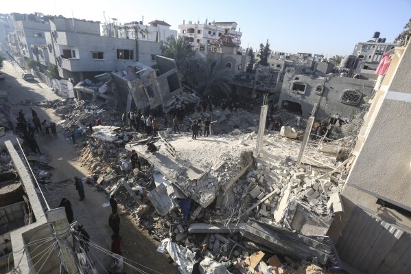 Palestinians look for survivors of the Israeli bombardment of the Gaza Strip in Rafah, Sunday, Dec. 3, 2023. (AP Photo/Hatem Ali)