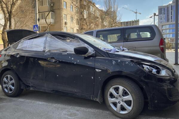 A car damaged by shelling that was used by Associated Press journalists to escape from the Mariupol blockade sits parked in Ukraine, Thursday, March 17, 2022. (AP Photo/Mstyslav Chernov)