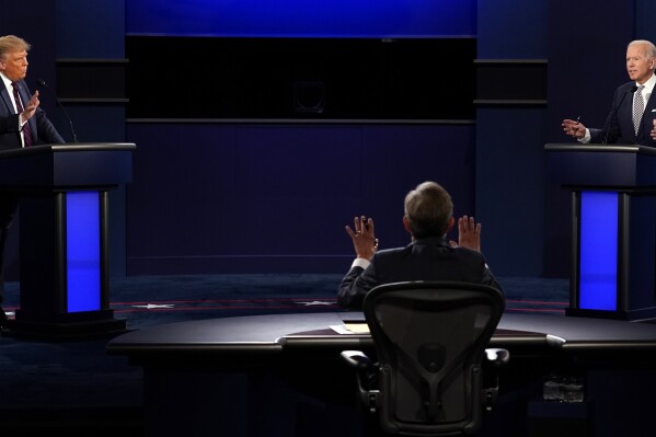 FILE - Chris Wallace, of Fox News, center, moderates as President Donald Trump, left, and Democratic candidate former Vice President Joe Biden, speak during the a presidential debate, Sept. 29, 2020, in Cleveland. Former President Trump is challenging President Joe Biden to debate, and Biden is laughing Trump off, at least publicly. There are real questions about whether any of the presidential candidates will confront each other on a debate stage in 2024. (AP Photo/Patrick Semansky, File)