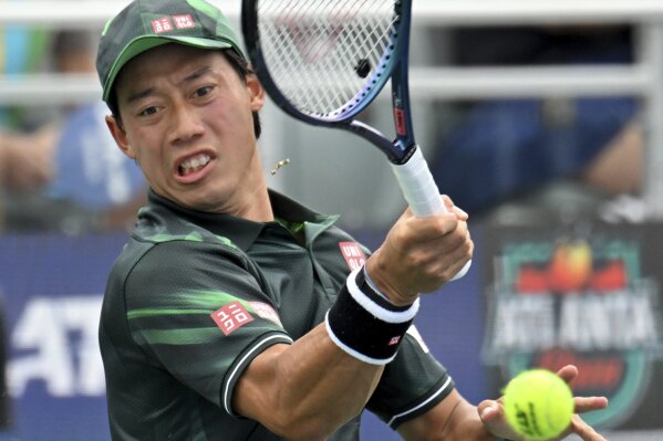 Kei Nishikori returns the ball to Taylor Fritz during a quarterfinal match at the Atlanta Tennis Open at Atlantic Station, Friday, July 28, 2023, in Atlanta. (Hyosub Shin/Atlanta Journal-Constitution via AP)