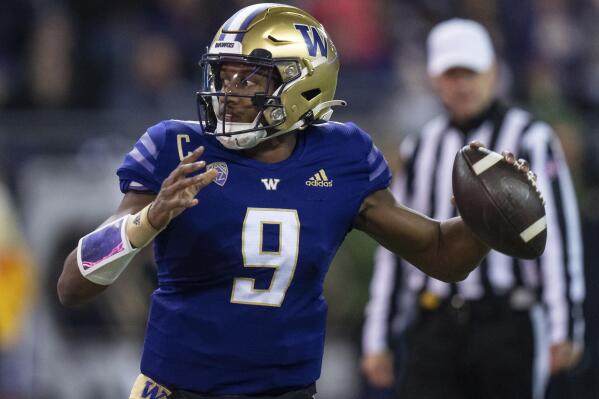 FILE - Washington quarterback Michael Penix Jr. looks to pass against Colorado during an NCAA college football game Nov. 19, 2022, in Seattle. Penix has opted to put off the NFL for another year and college football's leading passer leads the No. 12 Huskies against No. 21 Texas in the Alamo Bowl. (AP Photo/Stephen Brashear, File)