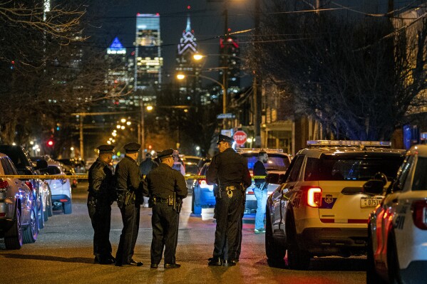 FILE - Police investigate the scene of a shooting, March 1, 2022, in Philadelphia. A fired Philadelphia police officer pleaded guilty Friday, April 19, 2024, to murder in the shooting of a fleeing 12-year-old boy, who prosecutors have said was on the ground and unarmed when the officer fired the fatal shot. (Tom Gralish/The Philadelphia Inquirer via AP, File)
