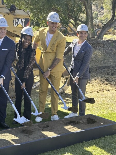 San Diego Padres slugger Manny Machado, center, a founding partner in the MLS expansion soccer club San Diego FC, participates in the ceremonial groundbreaking for a $150 million training complex and youth academy on Thursday, Nov. 9, 2023, in El Cajon, Calif. (AP Photo/Bernie Wilson)