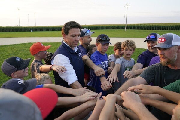 FILE - Republican presidential candidate Florida Gov. Ron DeSantis interacts with local players during a campaign stop at the Field of Dreams movie site, Thursday, Aug. 24, 2023, in Dyersville, Iowa. (AP Photo/Charlie Neibergall, File)