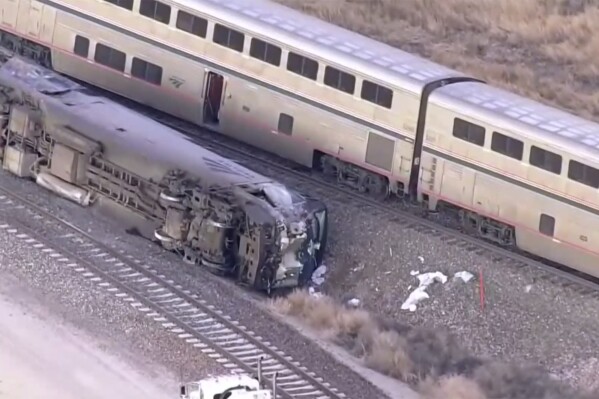 Emergency responders look over an Amtrak train derailment on Tuesday, Jan. 30, 2024 near Keenesburg, Colo. ( KMGH via AP)