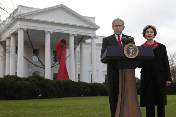 FILE - President George W. Bush makes a statement with first lady Laura Bush, right, on World AIDS Day, at the White House in Washington, Dec. 1, 2008 in Washington. The U.S. Global Leadership Coalition announced Thursday, Oct. 13, 2022, that it will honor Bush and the former first lady on World AIDS Day, Dec. 1, during its annual Tribute Celebration, for their work on combatting HIV/AIDS worldwide. (AP Photo/Evan Vucci, File)