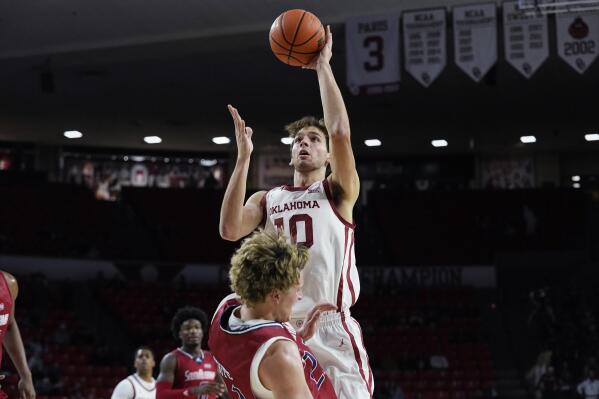 Oklahoma forward Sam Godwin (10) collides with South Alabama guard Owen White during the second half of an NCAA college basketball game Friday, Nov. 18, 2022, in Norman, Okla. (AP Photo/Sue Ogrocki)