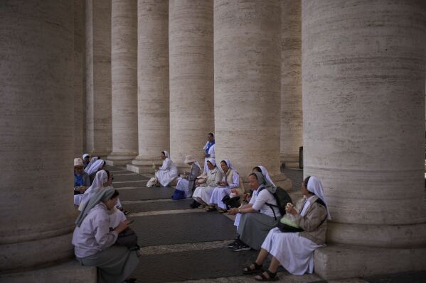 Nuns from Vietnam eat their lunch at St. Peter's square during the cardinals' conclave to elect a new pope, at the Vatican, Thursday, May 8, 2025. (AP Photo/Emilio Morenatti)