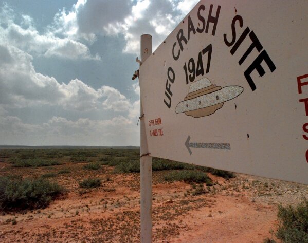 FILE - A sign directs travelers to the start of the "1947 UFO Crash Site Tours" in Roswell, N.M., June 10, 1997. World UFO Day is being celebrated amid a surge in sightings and government studies on unidentified flying objects. Its date of July 2nd has its roots in the so-called Roswell incident on July 2, 1947. (AP Photo/Eric Draper, File)