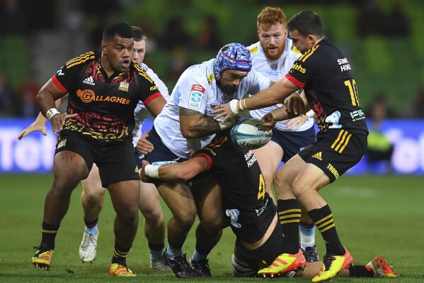 Tetera Faulkner of the Waratahs, center, in action during the Super Rugby Pacific Round 10 match between the Waikato Chiefs and the NSW Waratahs at AAMI Park in Melbourne, Friday, April 22, 2022. (James Ross/AAP Image via AP)