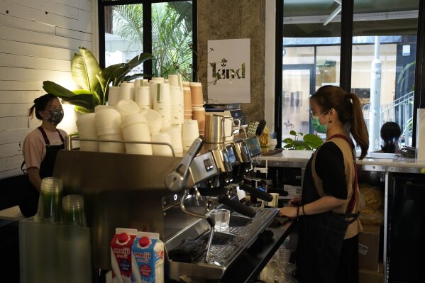 Employees work at the Found Cafe in Hong Kong on Sept. 13, 2020.  Cannabis, also known as marijuana, in Hong Kong may be illegal, but the new Found Cafe is offering a range of food and drinks that contain parts of the cannabis plant without breaking any local laws. (AP Photo/Vincent Yu)