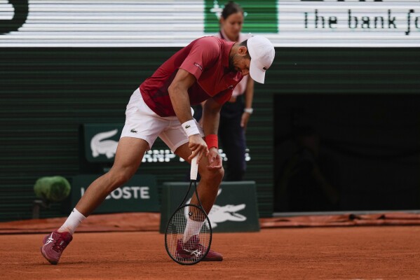 Serbia's Novak Djokovic reacts after missing a shot against Argentina's Francisco Cerundolo during their fourth round match of the French Open tennis tournament at the Roland Garros stadium in Paris, Monday, June 3, 2024. (AP Photo/Thibault Camus)