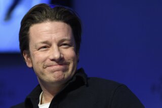 
              FILE - In this Wednesday, Jan. 18, 2017 file photo, British chef Jamie Oliver attends a panel session during the 47th annual meeting of the World Economic Forum, WEF, in Davos, Switzerland. Celebrity chef Jamie Oliver’s British restaurant chain has become insolvent, putting 1,300 jobs at risk. The firm said Tuesday May 21, 2019, that it had gone into administration, a form of bankruptcy protection, and appointed KPMG to oversee the process. (Laurent Gillieron/Keystone via AP, File)
            