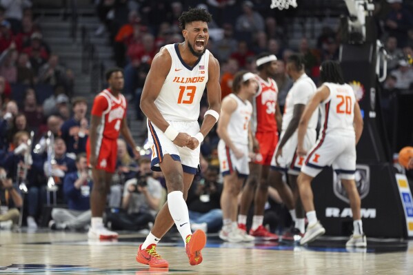 Illinois forward Quincy Guerrier (13) celebrates during the second half of an NCAA college basketball game against Ohio State in the quarterfinal round of the Big Ten Conference tournament, Friday, March 15, 2024, in Minneapolis. (AP Photo/Abbie Parr)