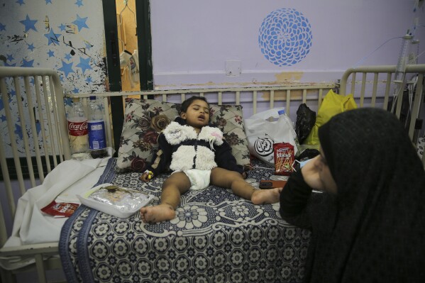A one-year-old Palestinian girl, Melicia Joudalost, was wounded in the Israeli bombardment at Aqsa Hospital in Deir al Balah City, Gaza Strip, Wednesday, Nov. 1, 2023. (AP Photo/Abdel Kareem Hana)