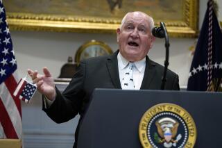 FILE - Then-Agriculture Secretary Sonny Perdue speaks at an event on the food supply chain during the coronavirus pandemic, in the Roosevelt Room of the White House, May 19, 2020, in Washington. Regents who run the University System of Georgia are scheduled to name a sole finalist to become chancellor of the system on Tuesday, Feb. 15, 2022, and Perdue has expressed interest in the job. (AP Photo/Evan Vucci, File)