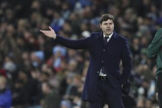 PSG's head coach Mauricio Pochettino gestures looking at an official during the Champions League group A soccer match between Manchester City and Paris Saint-Germain at the Etihad Stadium in Manchester, England, Wednesday, Nov. 24, 2021. (AP Photo/Scott Heppell)