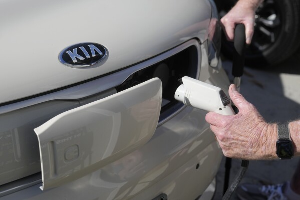 Ken Honeycutt demonstrates charging his Kia Soul electric vehicle in San Lorenzo, Calif., Nov. 9, 2024. (AP Photo/Jeff Chiu, File)