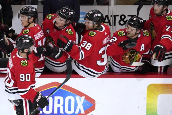 Chicago Blackhawks center Kirby Dach, right, celebrates his tying