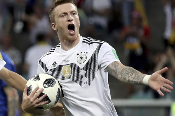 FILE - In this Saturday, June 23, 201 file photo Germany's Marco Reus after scoring his side's opening goal during the group F match between Germany and Sweden at the 2018 soccer World Cup in the Fisht Stadium in Sochi, Russia, Saturday, June 23, 2018. Germany coach Hansi Flick has made three new call-ups and recalled five players including Borussia Dortmund captain Marco Reus for next weeks' World Cup qualifiers. Flick continued the rebuilding started by his predecessor Joachim Löw as he called up Hoffenheim midfielder David Raum, Freiburg defender Nico Schlotterbeck and Salzburg forward Karim Adeyemi for the first time. (AP Photo/Thanassis Stavrakis, file)