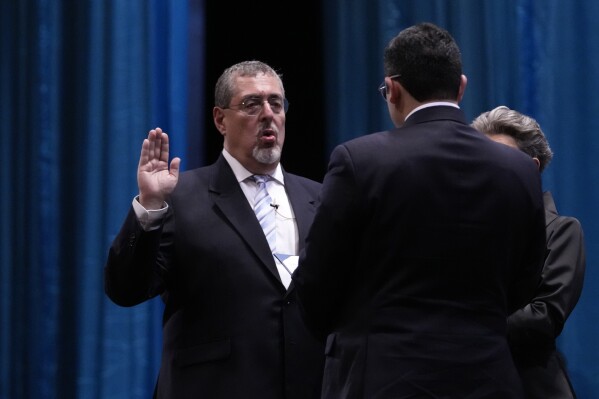 Incoming Guatemalan President Bernardo Arévalo takes the oath of office during his swearing-in ceremony in Guatemala City, early Monday, Jan. 15, 2024. (AP Photo/Moises Castillo)