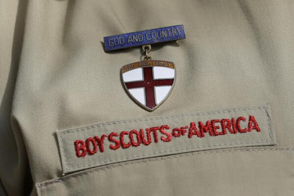FILE - This Feb. 4, 2013 file photo shows a close up of a Boy Scout uniform in Irving, Texas. Amid the Boy Scouts of America’s complex bankruptcy case filed in February 2020, there is worsening friction between the BSA and the major religious groups that help it run thousands of Scout units. At issue: the churches’ fears that an eventual settlement – while protecting the BSA from future sex-abuse lawsuits – could leave many churches unprotected. (AP Photo/Tony Gutierrez, File)