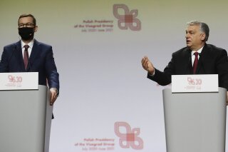 Prime Minister of Hungary Viktor Orban, right, and Polish Prime Minister Mateusz Morawiecki during a news conference at a meeting marking 30 years of central Europe's informal body of cooperation called the Visegrad Group, at a conference center in Krakow, Poland, Wednesday, Feb. 17, 2021. (AP Photo/Czarek Sokolowski)