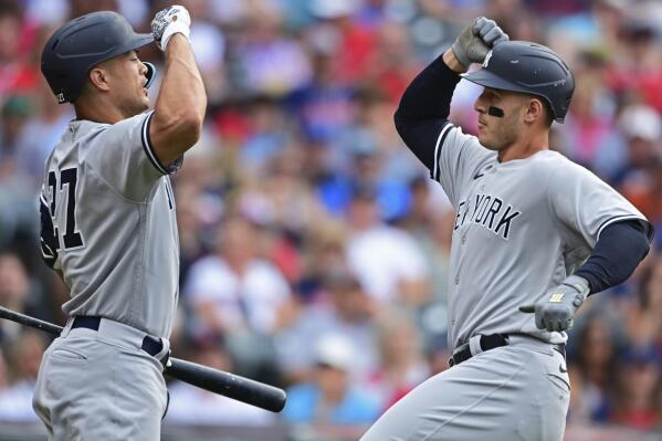 New York Yankees' Anthony Rizzo, right, is congratulated by Giancarlo Stanton after hitting a solo home run off Cleveland Guardians starting pitcher Aaron Civale during the fourth inning in the second baseball game of a doubleheader Saturday, July 2, 2022, in Cleveland. (AP Photo/David Dermer)