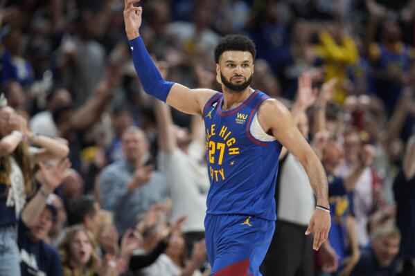 Denver Nuggets guard Jamal Murray gestures to the crowd after hitting a basket against the Phoenix Suns in the second half of Game 1 of an NBA second-round basketball series Saturday, April 29, 2023, in Denver. (AP Photo/David Zalubowski)