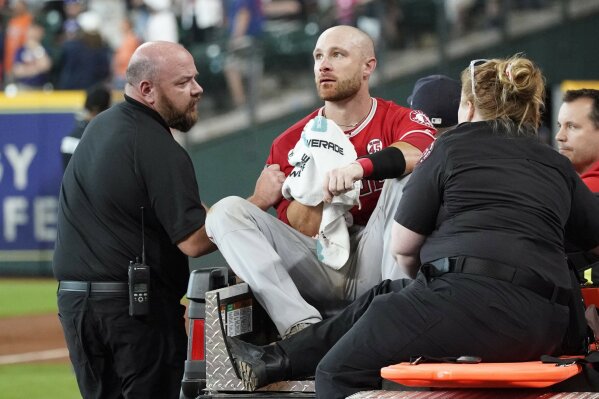 Los Angeles Angels' Jonathan Lucroy, center, is carted off the field after colliding with Houston Astros' Jake Marisnick at home plate during the eighth inning of a baseball game Sunday, July 7, 2019, in Houston. (AP Photo/David J. Phillip)