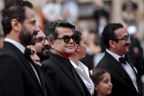 Director Jafer Panahi, centre, poses for photographers upon arrival at the premiere of the film 'It Was Just an Accident' at the 78th international film festival, Cannes, southern France, Tuesday, May 20, 2025. (Photo by Lewis Joly/Invision/AP)